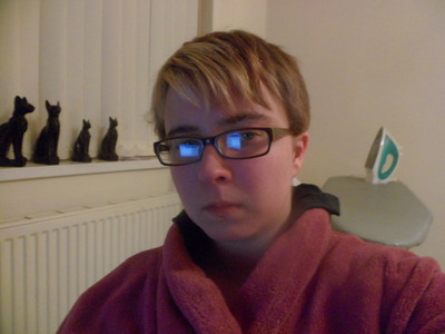 I've got pictures of myself on my profaili but this is the newest one i took...right now XD Yes i am in my dressings gown, yes that is my iron and ironing board behind me i have been ironing, no i am not smiling i am tired and unable to sleep. Um...oh and ignore the blonde bits in my hair, that's not natural..or it may be now. They're a result of bad dying when i dyed my fringe pink >.> Don't ask.