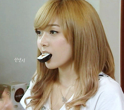  This is Jessica with blonde hair! She's eating something but I don't know what...........I know! Sushi!