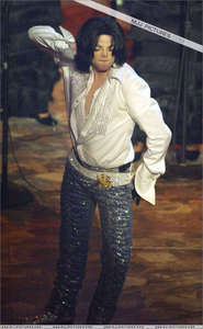 im very happy that you asked this question cause i had a MJ dream last night :) it was Invincible era and he looked like this (see the picture) but he had a v neck t-shirt and dark grey pants. he came out of his limo after a party because it was his 45th birthday and he was DRUNK! he held a less then half full bottle in his hand and he stumbled back to his house and it was paparazzi everywhere. he had a toothpick in his mouth and he was chewing gum. he looked really sexy even if he was pretty wasted xD but i've had many much weirder dreams about him too
