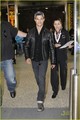 Taylor Lautner flashes his pearly whites as he walks through the airport on Saturday (August 20) - taylor-lautner photo