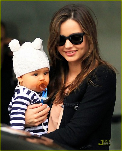Miranda Kerr carries her adorable son Flynn while catching a departing flight at the airport