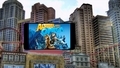 Alpha and omega logo on a tv screen in the city. - alpha-and-omega fan art