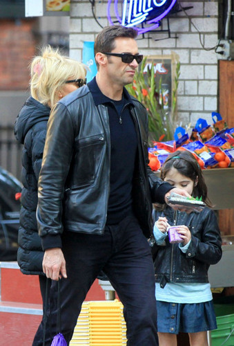 Hugh Jackman walks with his wife and daughter
