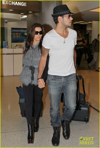  Eva Longoria holds hands with Eduardo Cruz while landing at the airport on (November 18 ) in Miami