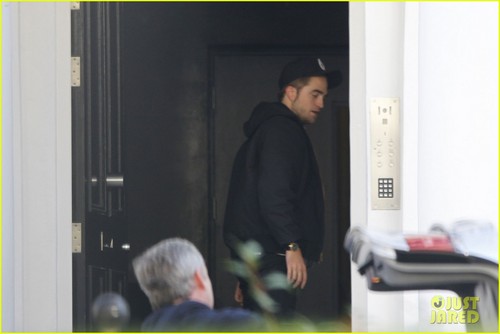  Robert Pattinson lets out a yawn as he enters a private residence on (November 19) in London
