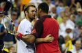 Jo-Wilfried Tsonga of France (R) and Mardy Fish of the US (L) embrace  - tennis photo