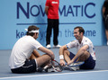 Del Potro meditates in front of the invisible campfire while Stepanek stares and laughs  - tennis photo