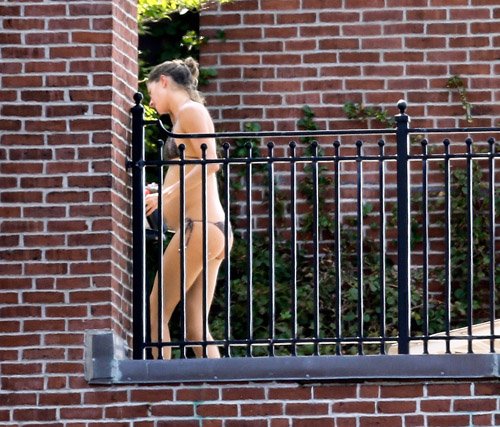  Gisele প্রদর্শিত হচ্ছে off her baby bump while sunbathing in a bikini in Boston (September 3)