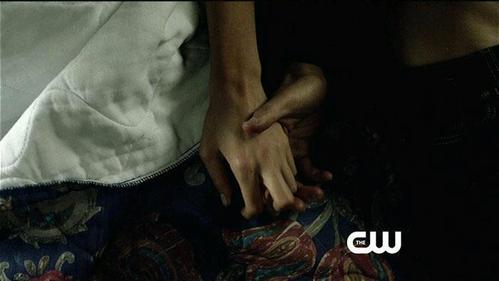  Who is caressing Elena's hand?