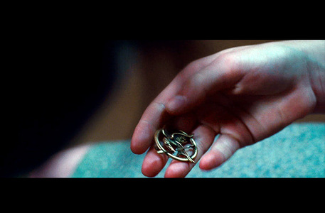  Who gave Katniss the MockingJay pin in the book?