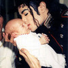 Baby gets MJ kiss! Michael in an orphanage in Romania 1992. Vespera photo