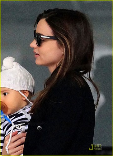  Miranda Kerr carries her adorable son Flynn while catching a departing flight at the airport