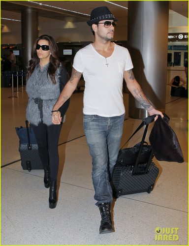 Eva Longoria holds hands with Eduardo Cruz while landing at the airport on (November 18 ) in Miami