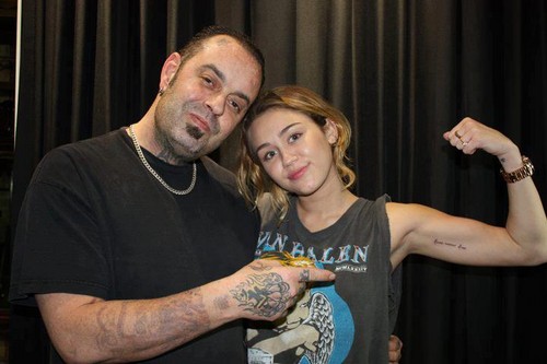  Miley's new tattoo it says "Love Never Dies"