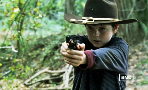  carl with a gun wearing his hat