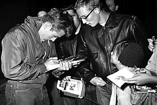  James signing the autographs