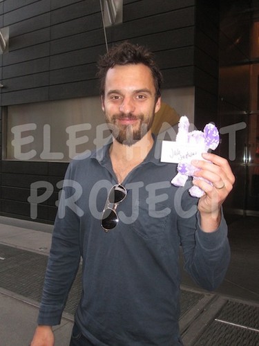  Jake M. Johnson posing with the 코끼리 beanie baby to help fight Alzheimer’s disease
