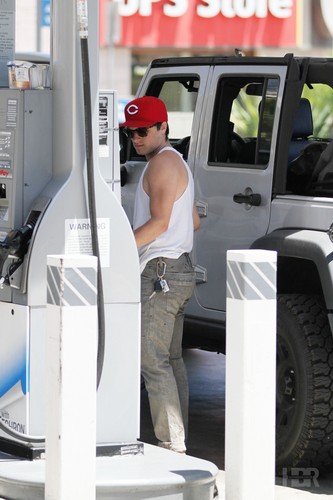  Josh puts gas in his car with his dog, Driver.
