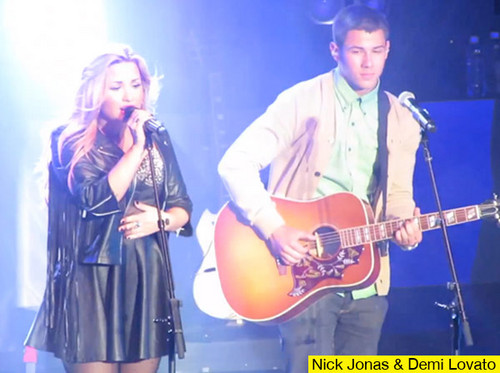  Nick Jonas accompanies Demi Lovato on stage