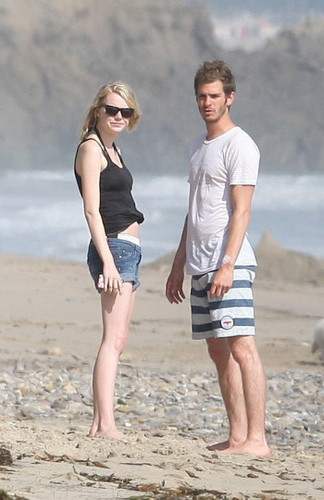 Andrew & Emma kissing on the beach