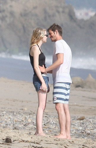 Andrew & Emma kissing on the beach