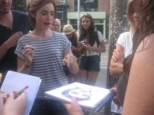  Lily signing autographs on the set of cite of Bones