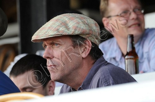 Hugh Laurie watching a horse race at Saratoga Springs, NY